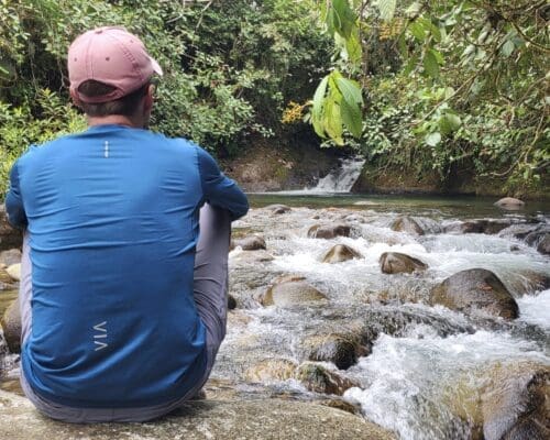 A lone hiker takes a rest by Eco Cabaña Junin's natural swimming hole.